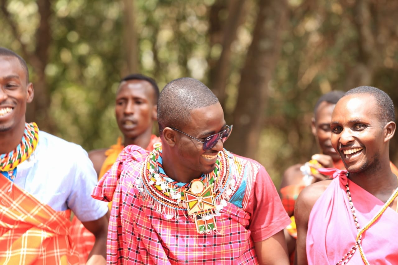 Nelson Madiba Amo among community members during a field visit